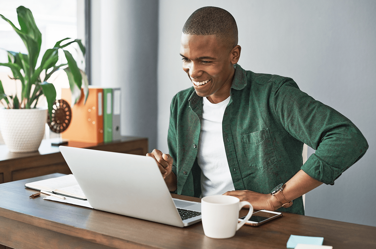 Man smiling at a laptop