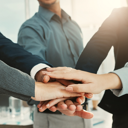 Hands on top of each other as people come together