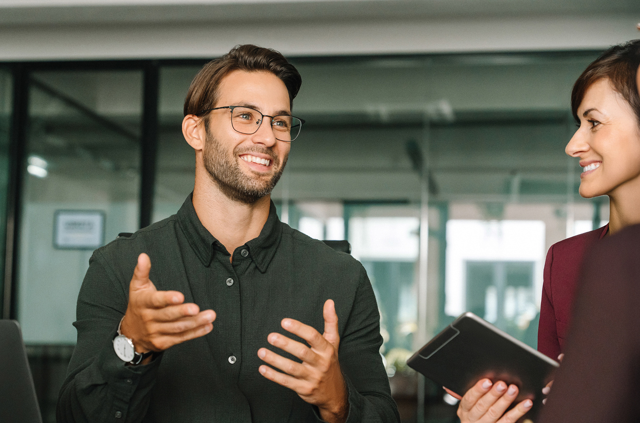 Man conversing with colleagues