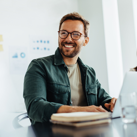 Man at a laptop smiling