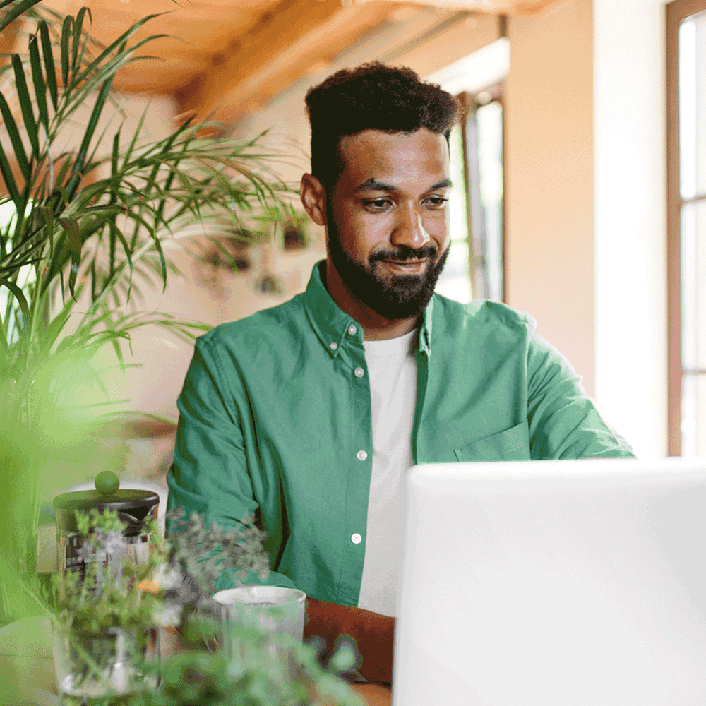 Man in office using laptop to hire candidates