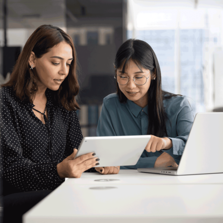 Two women reviewing integrations on their tablet