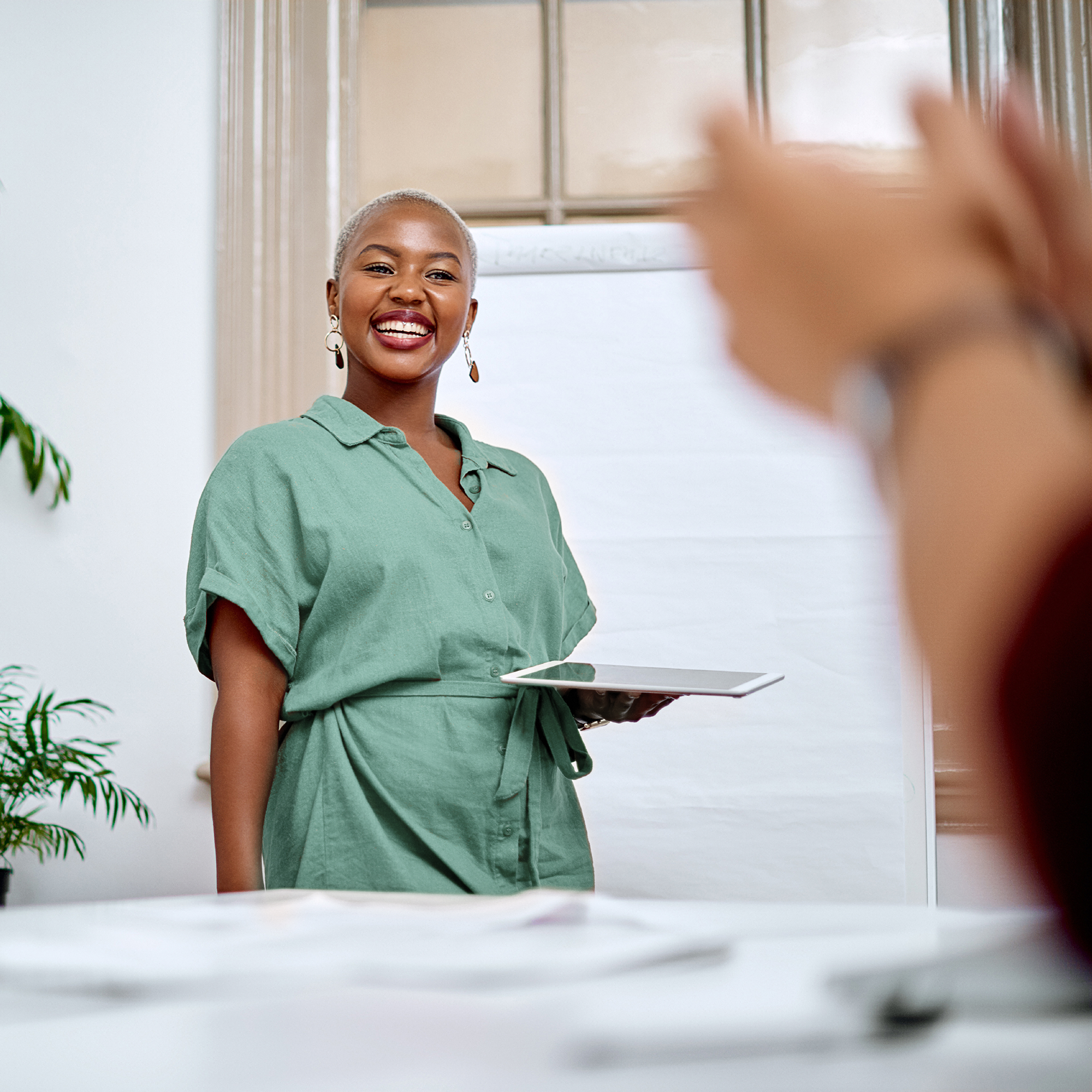 smiling woman cheered on by co-workers