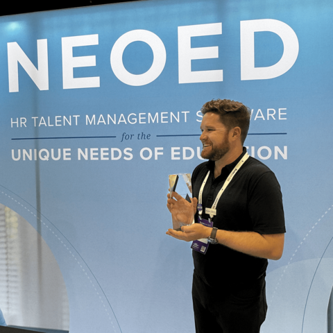 NEOED employee receiving an award at an event