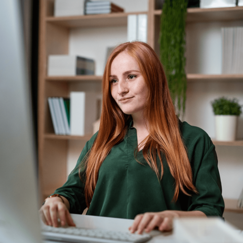 Woman smiling looking at a laptop