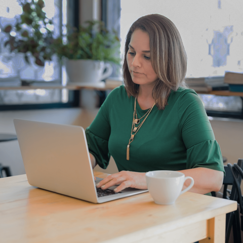 Woman looking thoughtfully at a computer