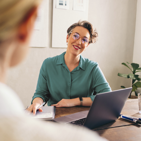 Woman at a laptop interviewing a candidate