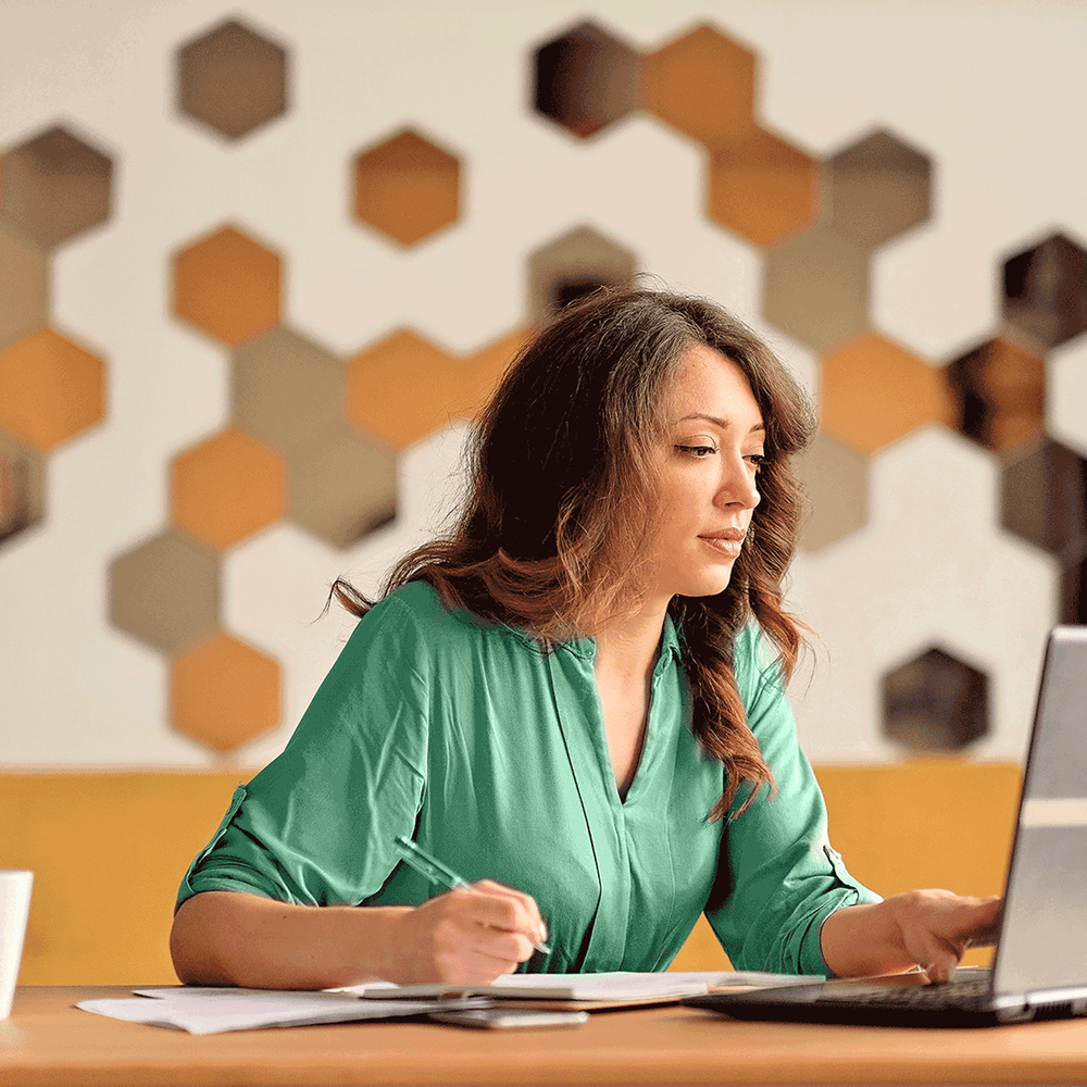 Woman reviewing onboarding tasks on her laptop