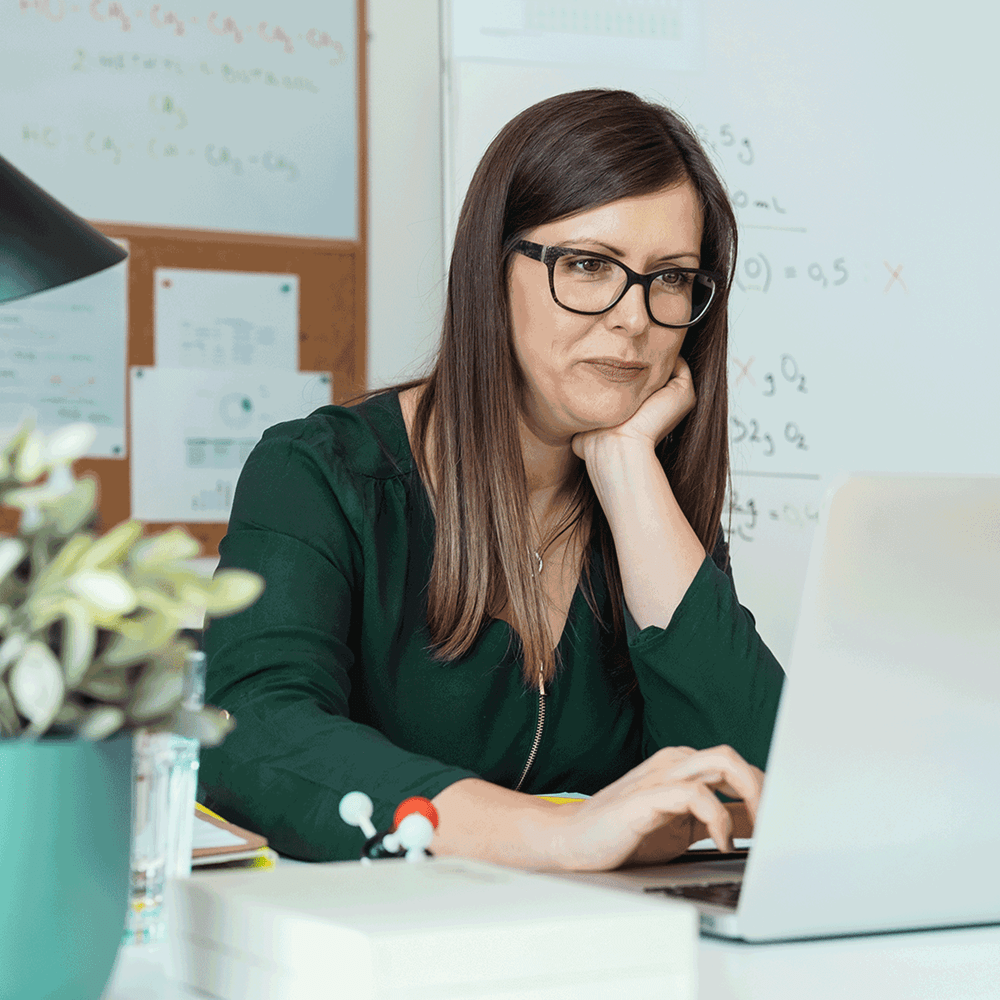 Woman reviewing performance metrics on a laptop