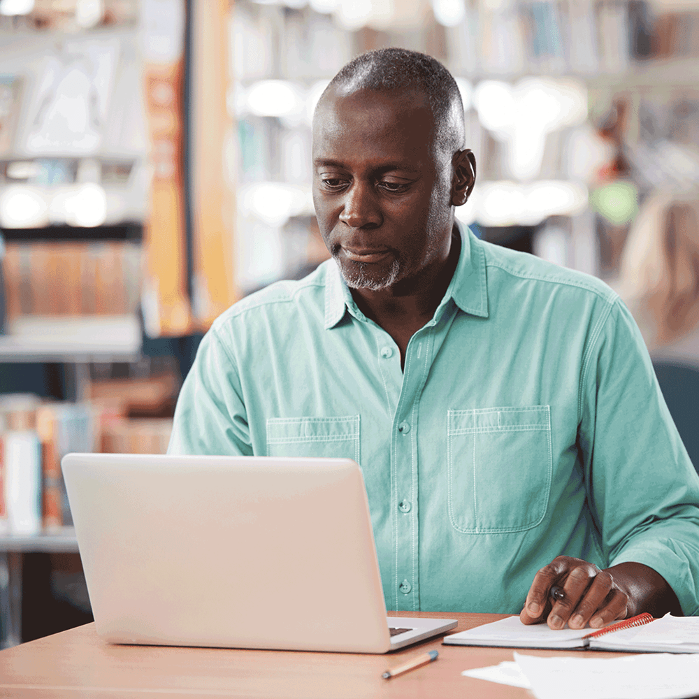 Man reviewing performance data on his laptop