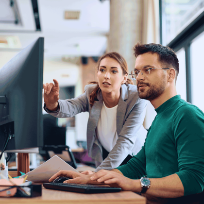 man and women looking at computer 