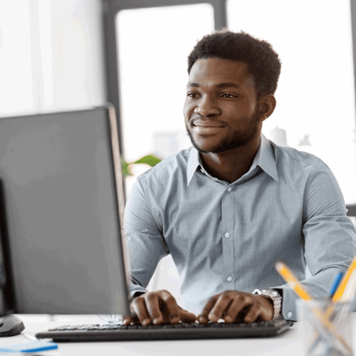 Man working on a policy on his laptop
