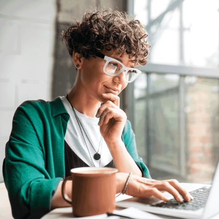 Woman on computer thinking about candidate pipeline