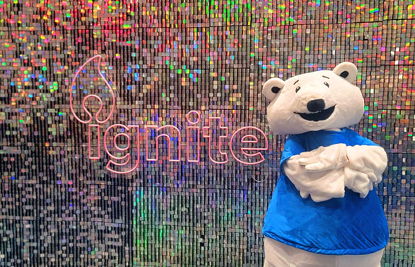 Mascot Sparky in front of an Ignite sign